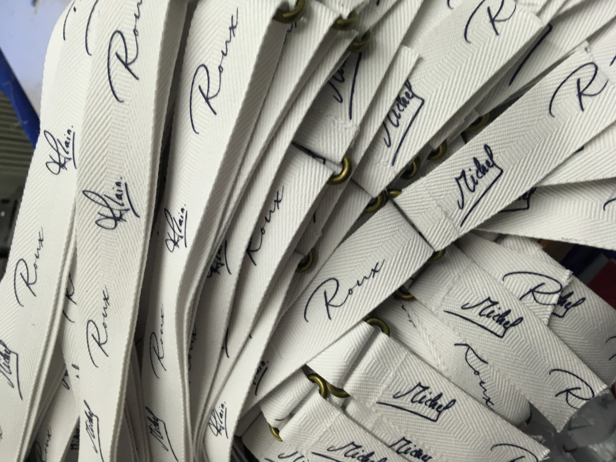 Apron strap woven signature in the strap - Michelle & Alan Roux