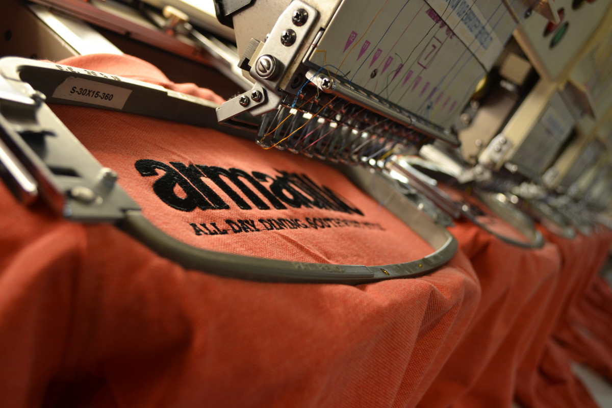 Embroidering a sample logo on polo shirt Embroidering a sample logo on polo shirt